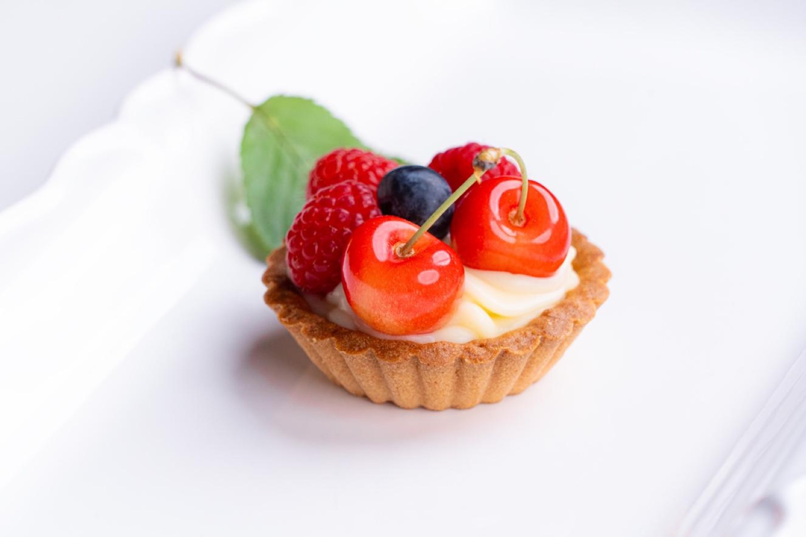 Fresh fruit tart with cherries and raspberries